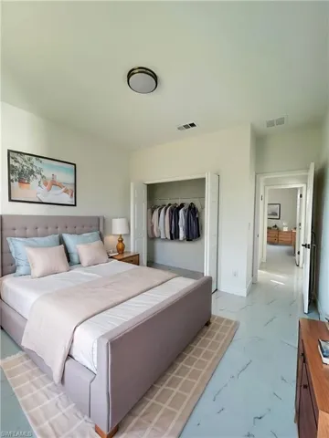 Virtually staged bedroom with a closet and baseboards