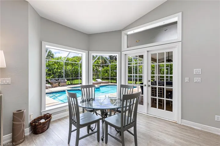 Angled walls with multiple windows offer expansive views of the outdoor pool area