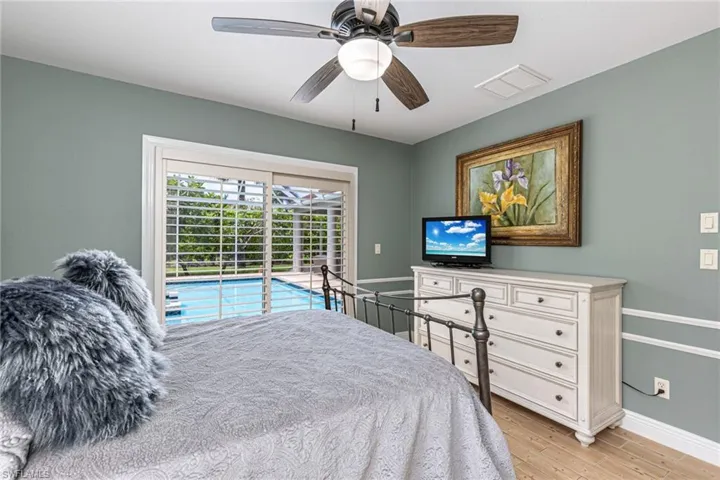 Sliding glass doors with plantation shutters open to a pool area