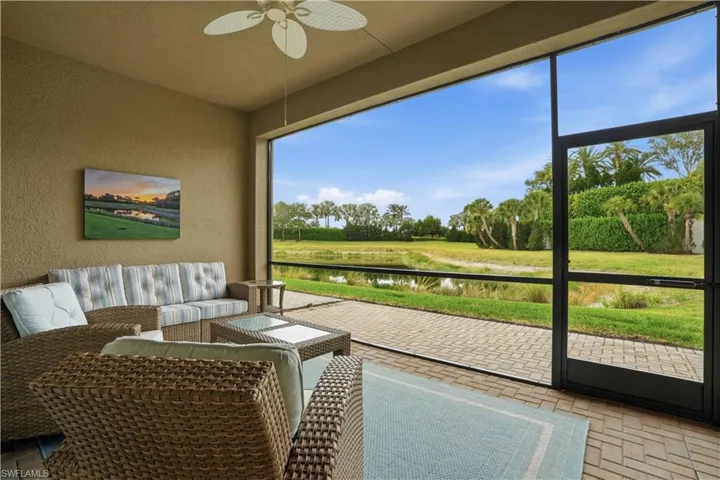 Sunroom / solarium with a ceiling fan, a water view, and outdoor lounge area