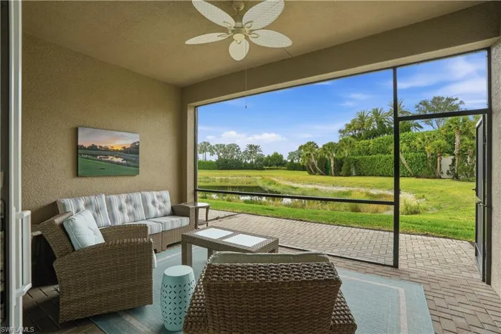 Sunroom / solarium featuring ceiling fan, a water view, and an outdoor hangout area