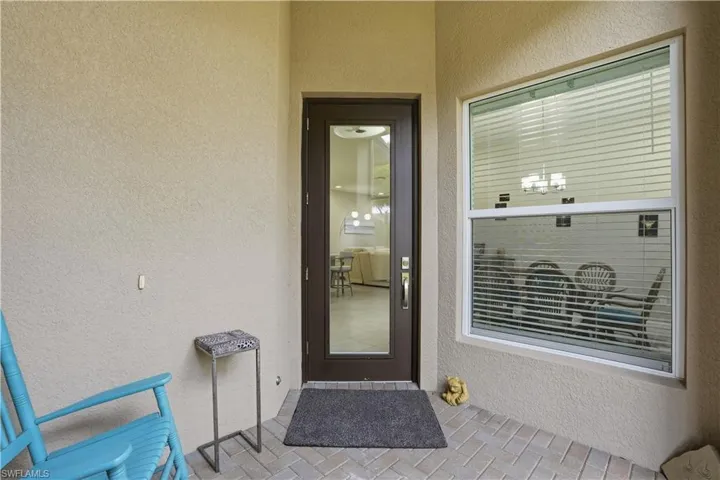 Doorway to property with stucco siding and a patio area