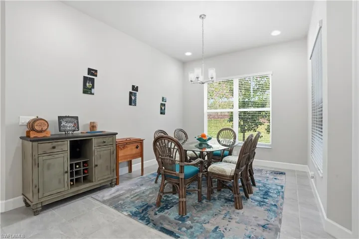 Dining room with a chandelier, recessed lighting, and light tile patterned floors