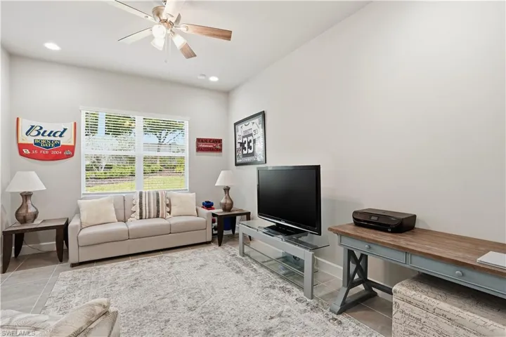 Living area with ceiling fan, recessed lighting, and light tile patterned floors