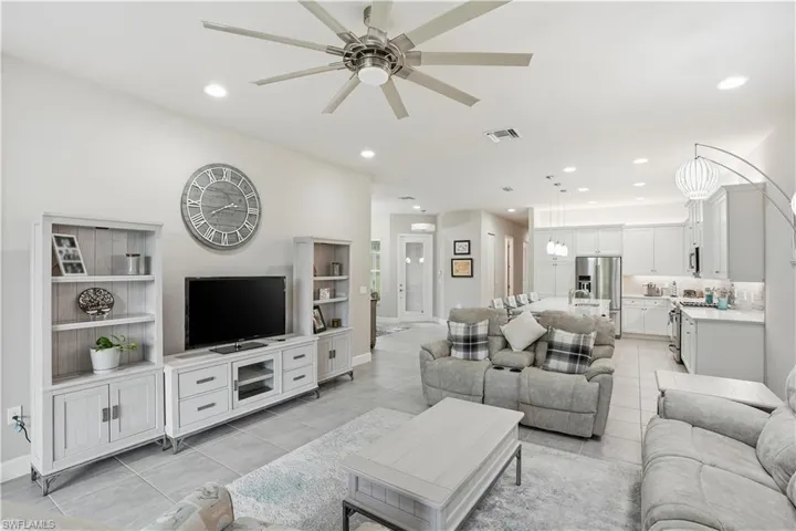 Living room with recessed lighting, ceiling fan, and light tile patterned floors