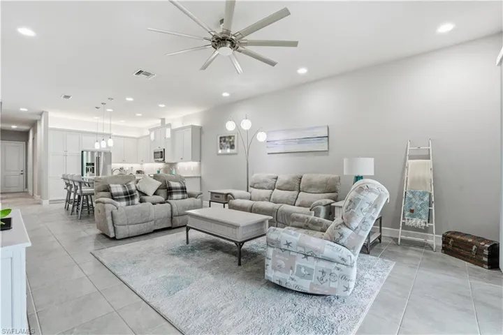 Living area featuring recessed lighting and a ceiling fan