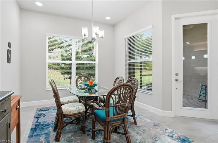Dining room featuring a chandelier, healthy amount of natural light, and light tile patterned floors