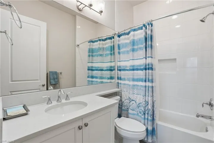 Bathroom with vanity and shower / bathtub combination with curtain