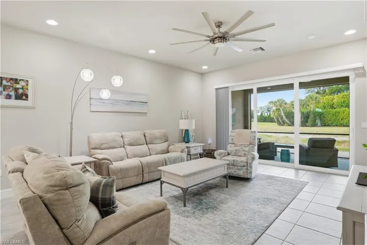 Living area with a ceiling fan and recessed lighting