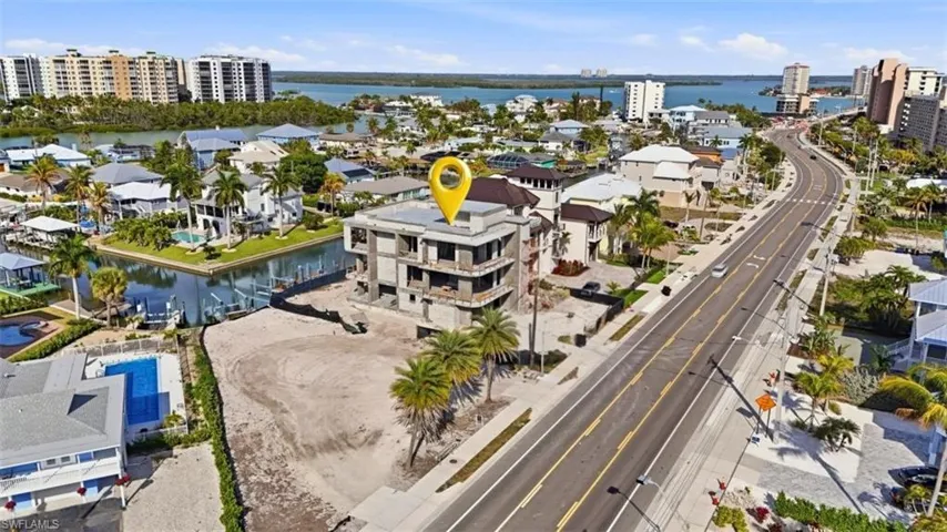 Drone / aerial view of a large body of water and apartment complex - Virtually Edited Image