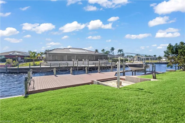 The dock extends into the water, offering a perfect spot for fishing or relaxing by the shore.