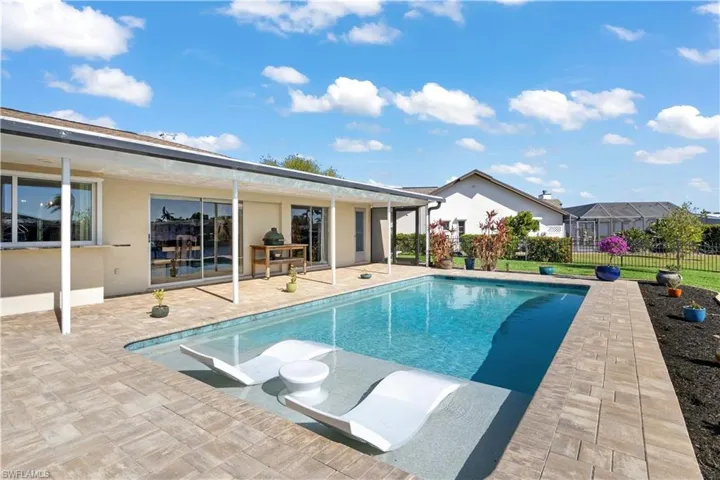 The pool is surrounded by elegant pavers that create a clean, seamless transition from the water to the surrounding outdoor space.