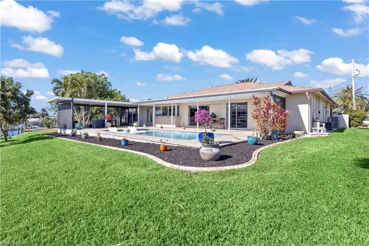The back view of a pool area can offer a serene and inviting atmosphere, often serving as a focal point for outdoor living.