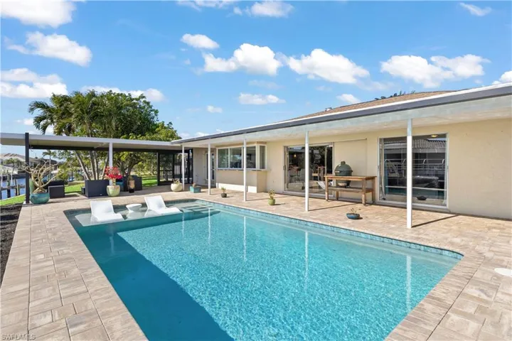 The pool's sleek design features smooth, contemporary lines, with a spacious shallow area perfect for lounging or dipping your toes in.