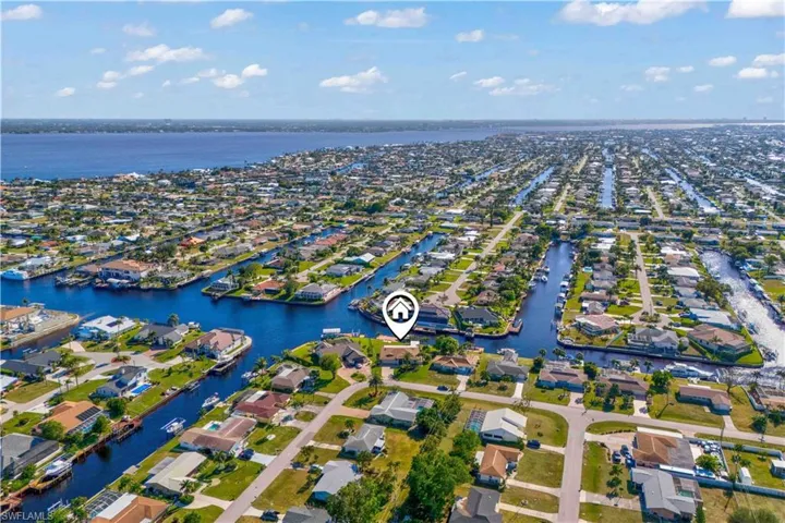 From above, the community showcases organized layouts, scenic water features, and tree-lined roads creating a peaceful neighborhood atmosphere.