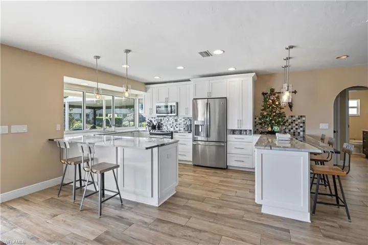 Custom spotlighting highlights the beautiful backsplash, adding a touch of elegance to the space.