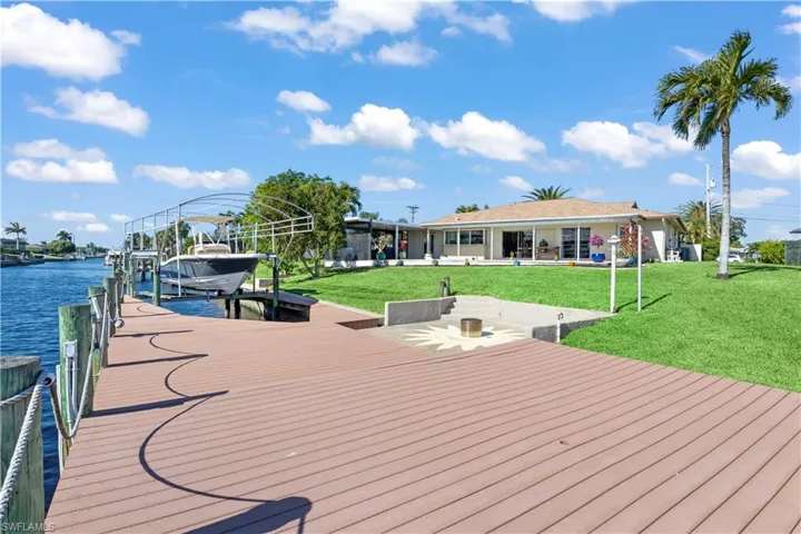 The deck offers a spacious, stylish outdoor area with seating and a fire pit, ideal for relaxation and entertaining.