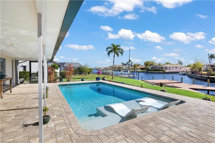 Relax in the sparkling pool while taking in serene, wide canal views—your private waterfront retreat just minutes from open water!