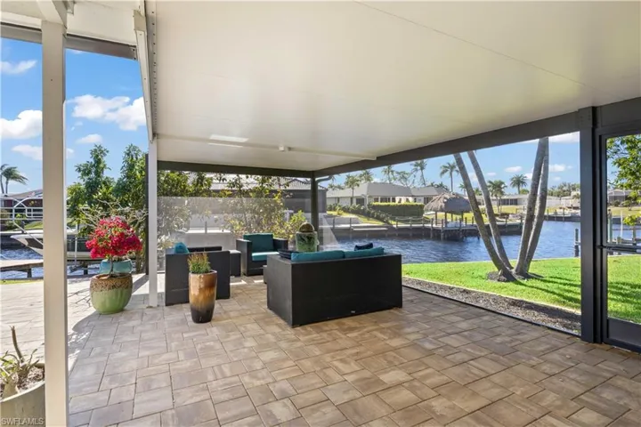 The covered seating area provides a shaded retreat with comfy chairs and a peaceful vibe.