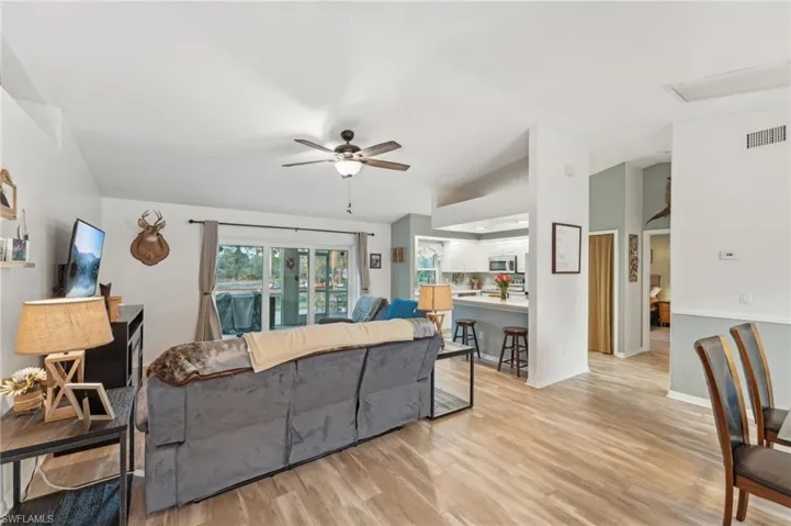 Living room with ceiling fan and light wood-type flooring
