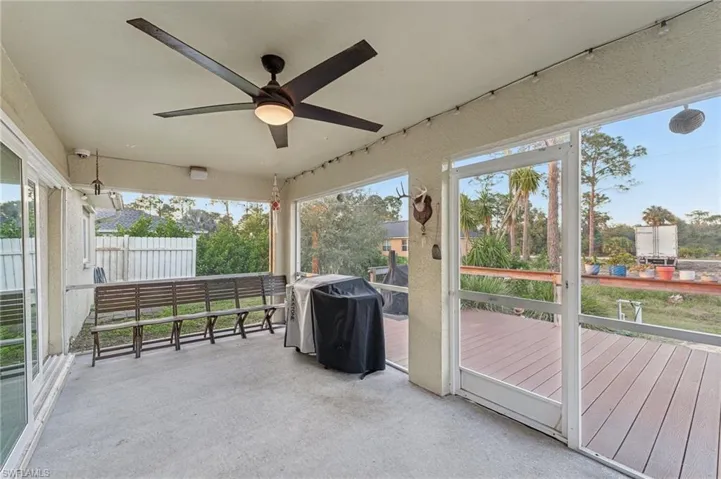 Unfurnished sunroom with ceiling fan and a healthy amount of sunlight