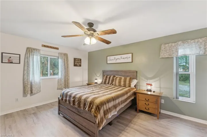 Bedroom featuring ceiling fan and light hardwood / wood-style floors