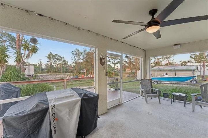 Sunroom / solarium featuring ceiling fan