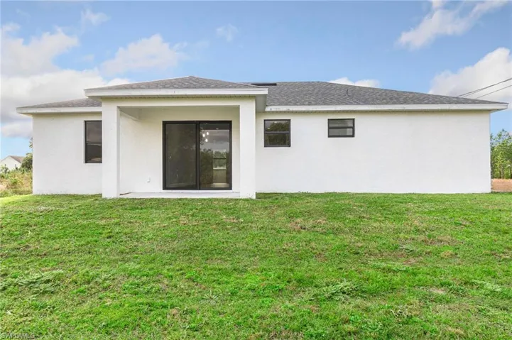 Rear view of property featuring a yard