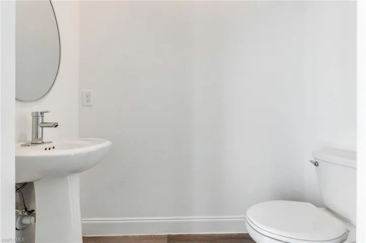 Bathroom with sink, hardwood / wood-style flooring, and toilet