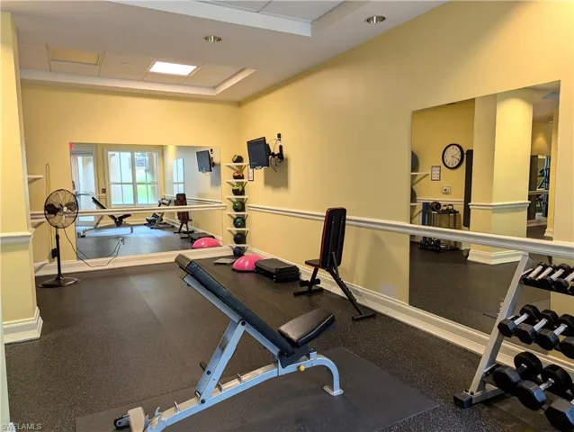 Workout area featuring a raised ceiling