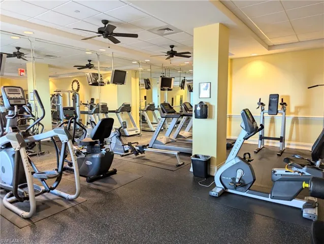 Workout area with a drop ceiling and ceiling fan