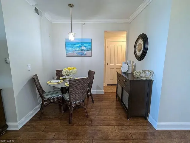 Dining room featuring crown molding and dark hardwood / wood-style floors
