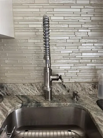 undermount kitchen sink with decorative faucet and beautiful backsplash
