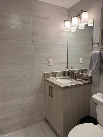 Floor to ceiling tiles, custom vanity.  Ceiling was raised for additional light and height.