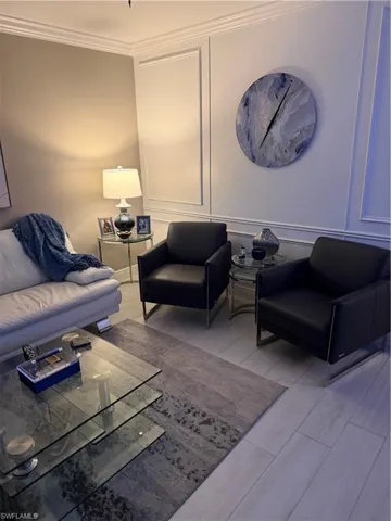Living room with a decorative wall and ornamental molding