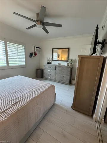 Bedroom featuring ceramic floors, ceiling fan, and ornamental crown molding