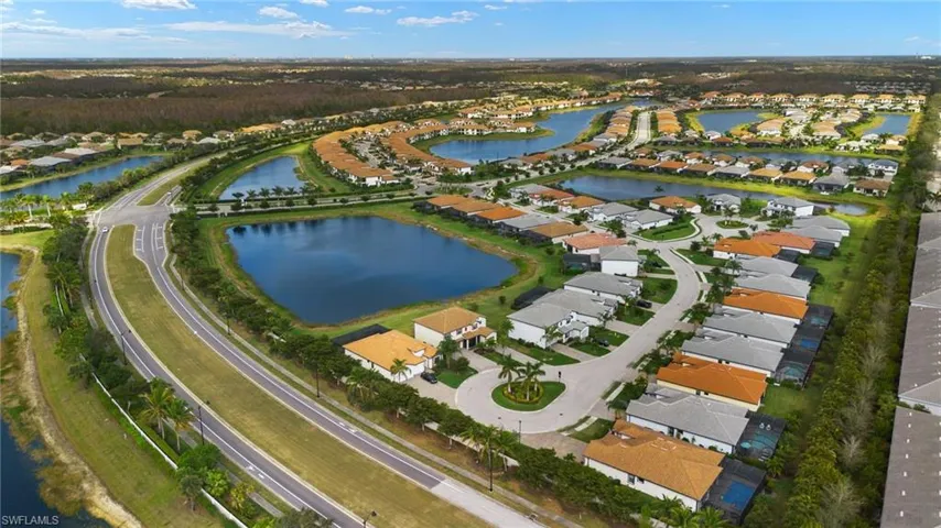 Birds eye view of property with a water view