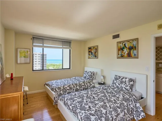 Bedroom with wood-type flooring and baseboards