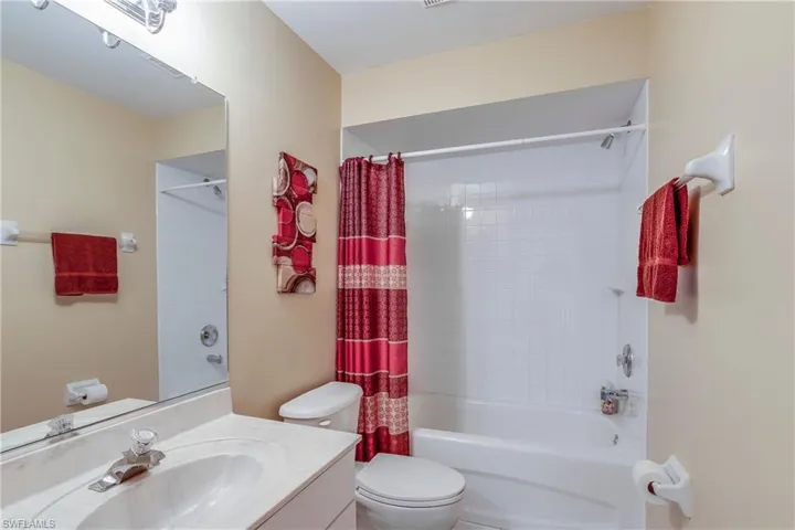 Full bathroom featuring vanity, shower / tub combo, and toilet