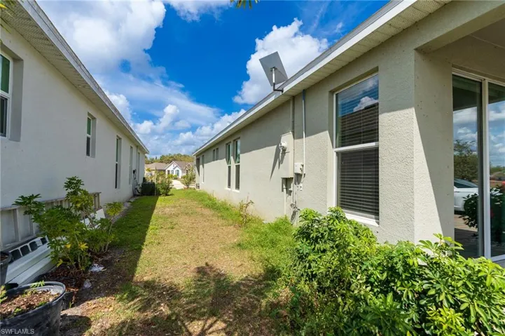 View of home's exterior featuring stucco siding and a yard