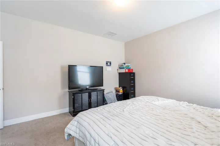 Carpeted bedroom featuring baseboards