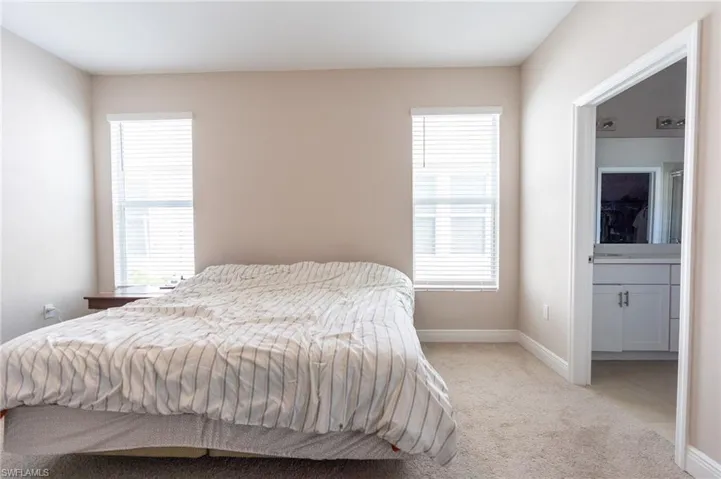 Carpeted bedroom with baseboards