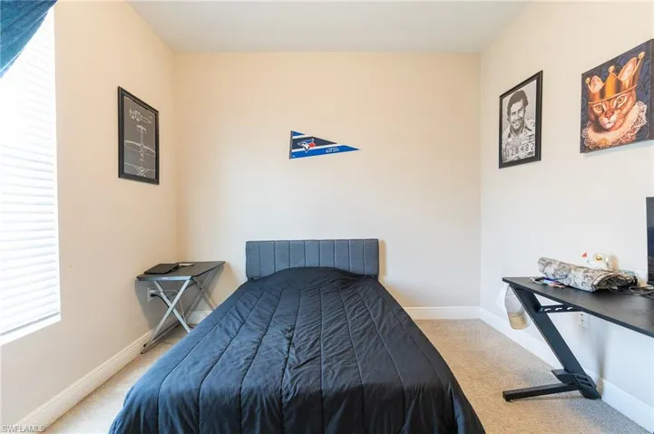 Bedroom featuring light colored carpet