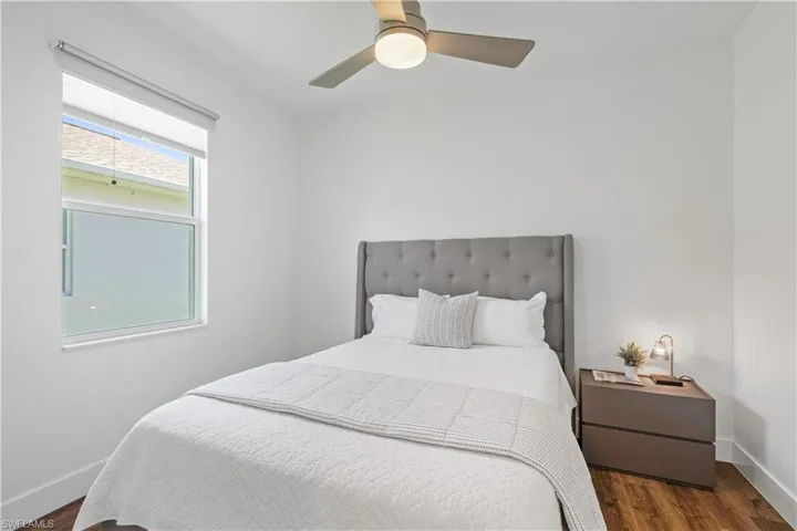 Bedroom featuring dark wood-style floors and ceiling fan