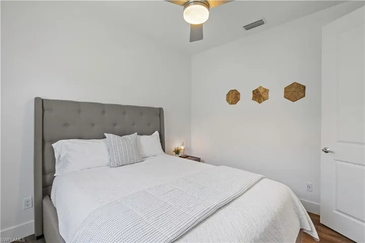 Bedroom with a ceiling fan and wood finished floors