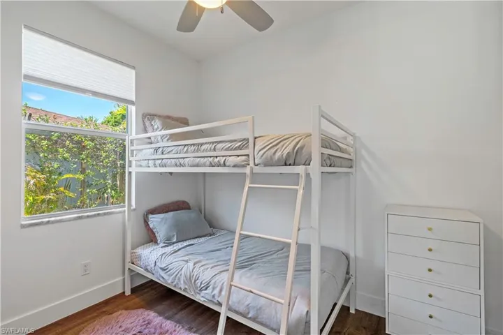 Bedroom featuring dark wood finished floors and a ceiling fan