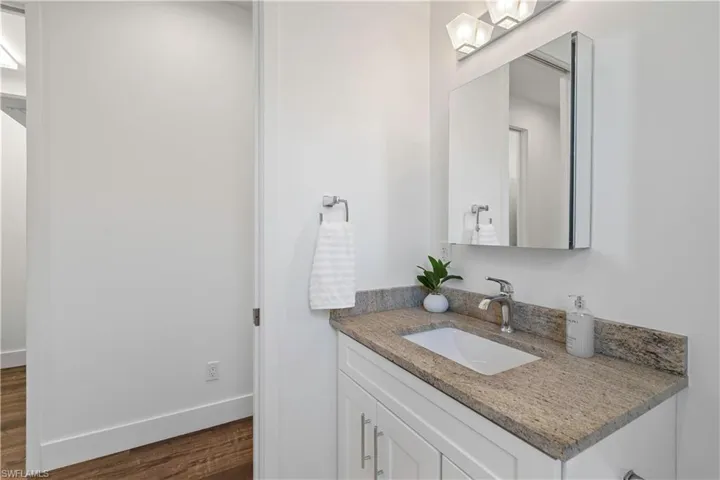 Bathroom with vanity and dark wood-style flooring