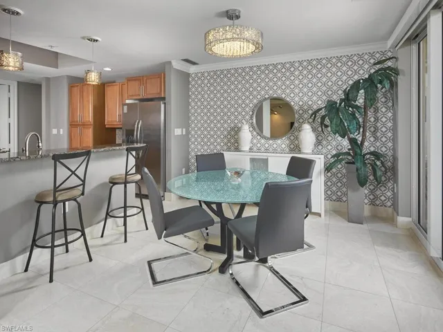 Dining area with lovely feature wall, conveniently located next to the kitchen.