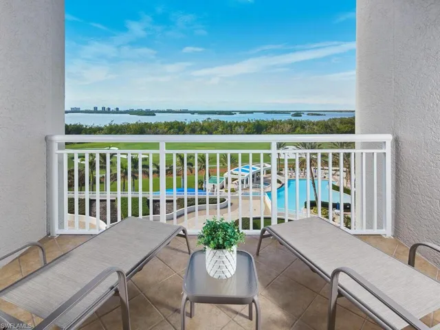 An additional balcony space with a peaceful view of the pool and the bay, just off the primary bedroom.