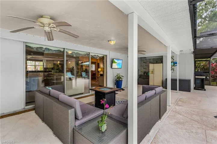 View of patio with ceiling fan and an outdoor living space